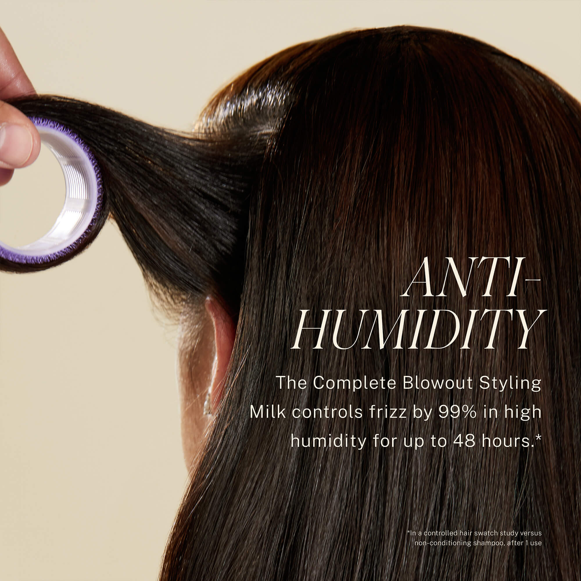 Back of model's head who has brown hair. Text reads Anti-Humidity, The Complete Blowout Styling Milk controls frizz by 99% in high humidity for up to 48 hours.