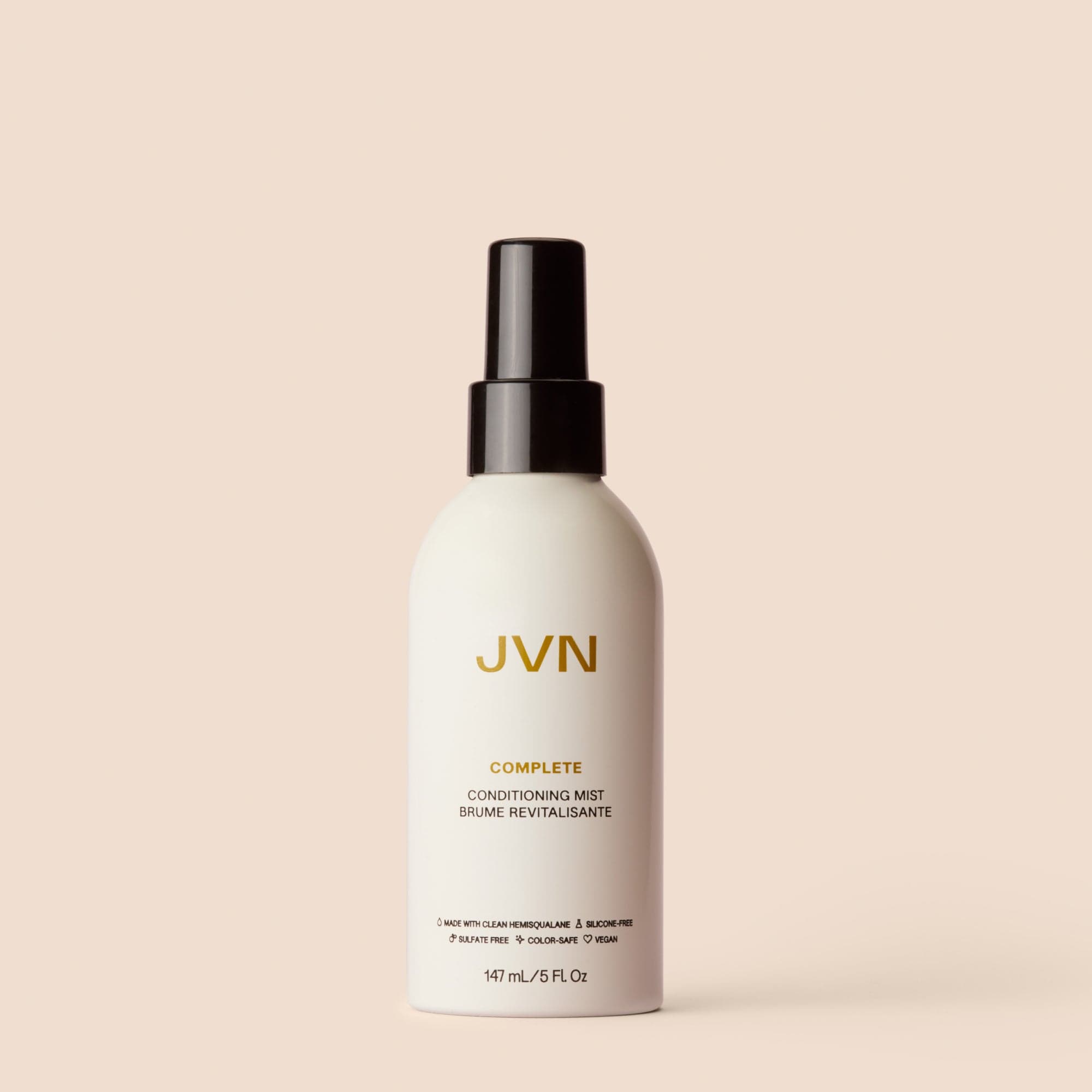 Product image of the Complete Conditioning Mist on pink background.