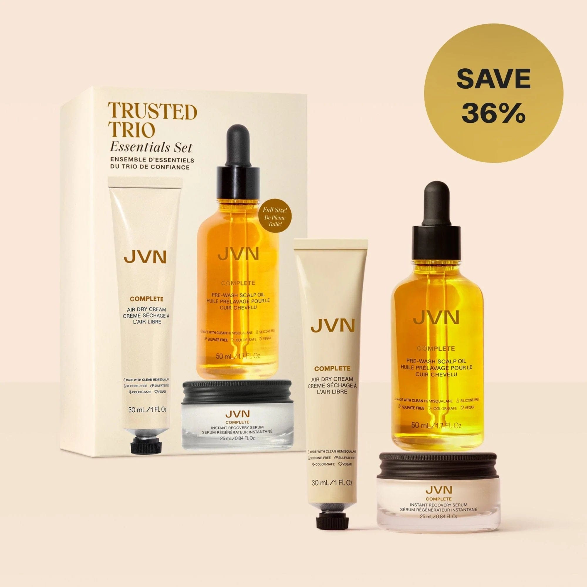 Trusted Trio Essentials Set (Complete Air Dry Cream Travel Size, Complete Instant Recovery Serum Travel Size, and Complete Pre-Wash Scalp Oil Full Size) on pink holiday motif. Ornament graphic indicates set is 36% off