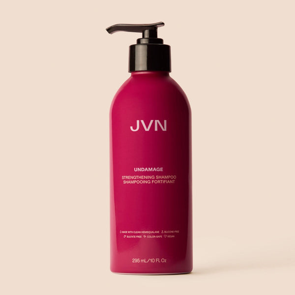 Product image of the Undamage Strengthening Shampoo on pink background.